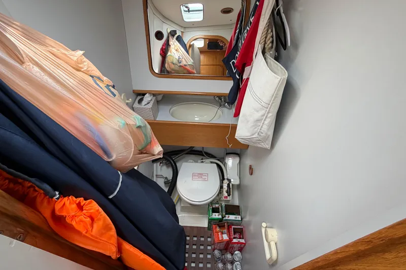 Slide: The Image of Bathroom interior of 1988 Beneteau Oceanis 390 yacht with storage and mirror. - 29