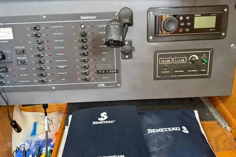 Slide: The Image of Control panel of a 1988 Beneteau Oceanis 390 yacht with manuals and equipment. - 28