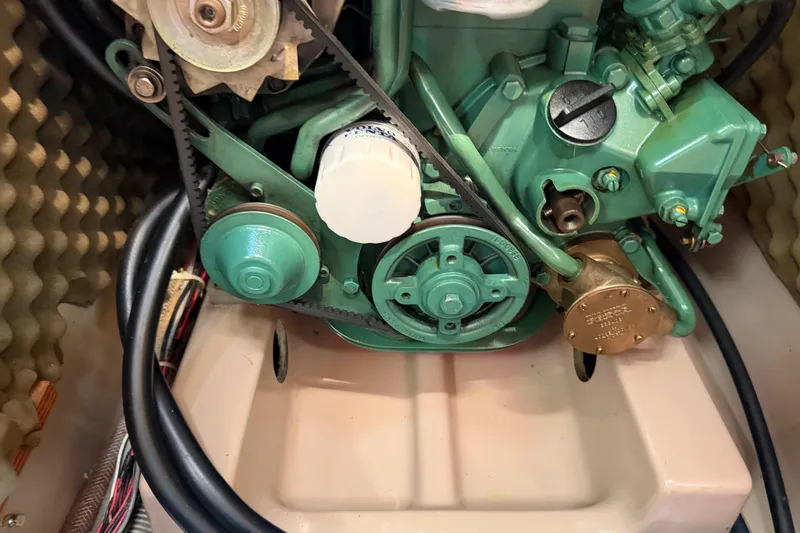 Slide: The Image of Engine compartment of a 1988 Beneteau Oceanis 390 sailboat, showcasing mechanical components. - 36