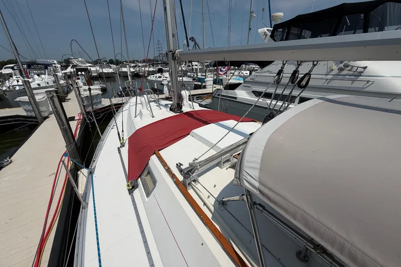 Slide: The Image of 1988 Beneteau Oceanis 390 sailboat docked at marina, surrounded by other boats. - 10