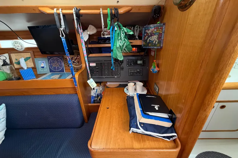 Slide: The Image of Interior of 1988 Beneteau Oceanis 390 sailboat with navigation station and wooden cabinetry. - 18