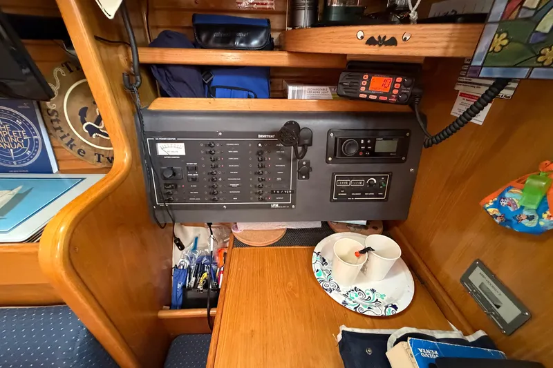 Slide: The Image of Control panel inside a 1988 Beneteau Oceanis 390 sailboat cabin with navigation equipment. - 19