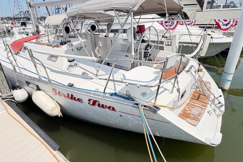 Slide: The Image of 1988 Beneteau Oceanis 390 sailboat named "Strike Two" docked at marina. - 7