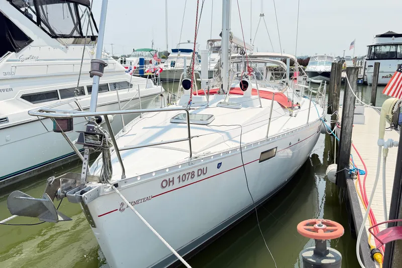Slide: The Image of 1988 Beneteau Oceanis 390 sailboat docked at marina, side view. - 2