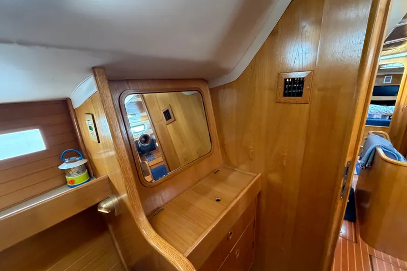 Slide: The Image of Interior of 1988 Beneteau Oceanis 390 sailboat with wooden cabinetry and mirror. - 36