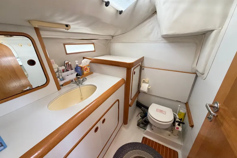 Slide: The Image of Interior of 1988 Beneteau Oceanis 390 yacht bathroom with sink and toilet. - 31