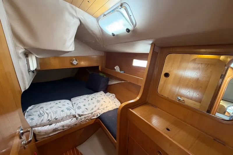 Slide: The Image of Cozy cabin interior of 1988 Beneteau Oceanis 390 sailboat with wooden furnishings. - 24