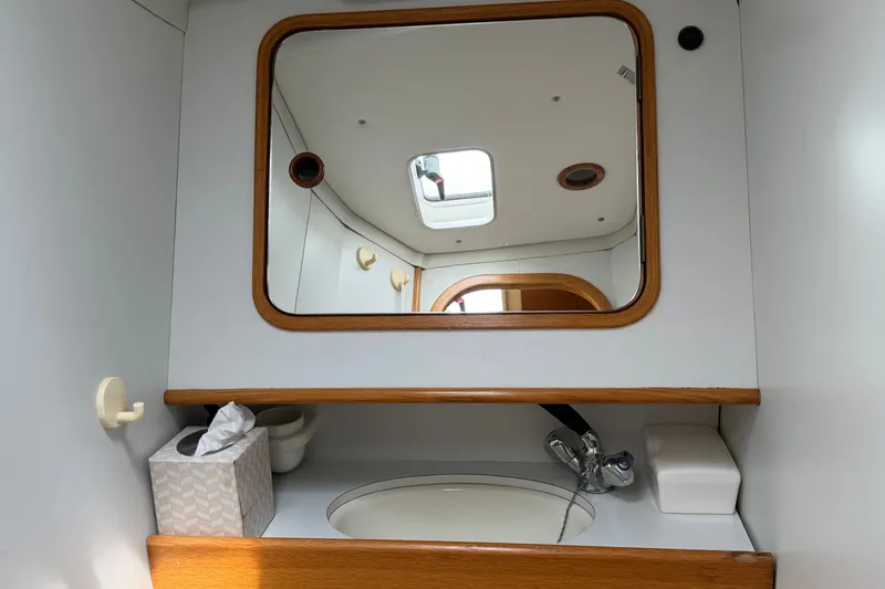 Slide: The Image of Bathroom vanity with mirror and sink in 1988 Beneteau Oceanis 390 yacht. - 38