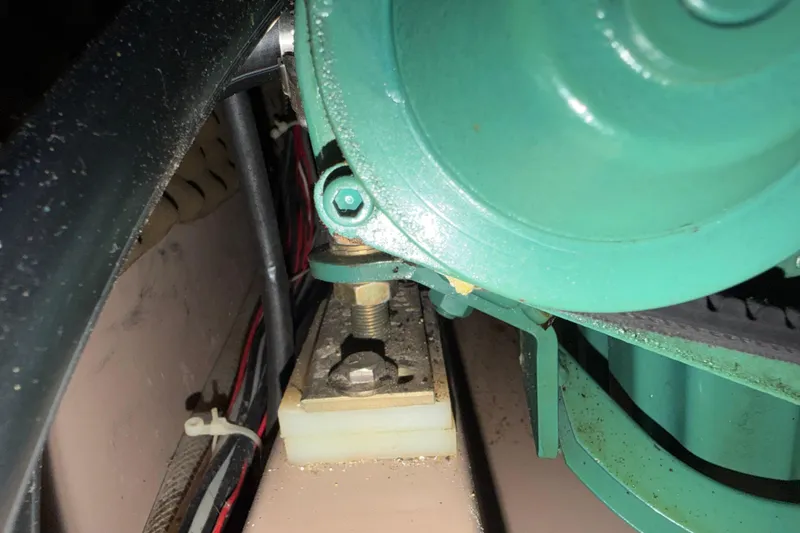 Slide: The Image of Engine component of a 1988 Beneteau Oceanis 390 sailboat, featuring green machinery and wiring. - 38