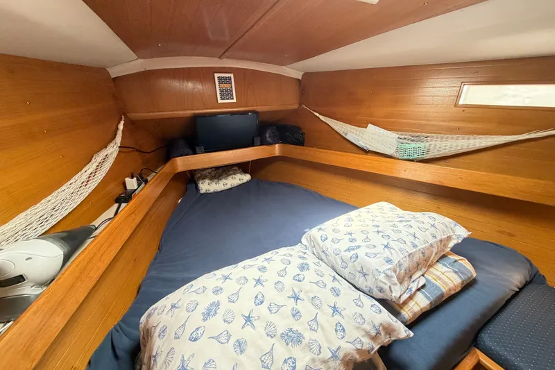 Slide: The Image of Cozy cabin interior of 1988 Beneteau Oceanis 390 sailboat with wooden finish and nautical decor. - 35