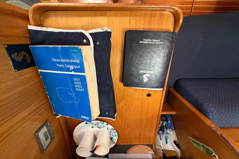 Slide: The Image of Interior of 1988 Beneteau Oceanis 390 with manuals and parts catalogue. - 20