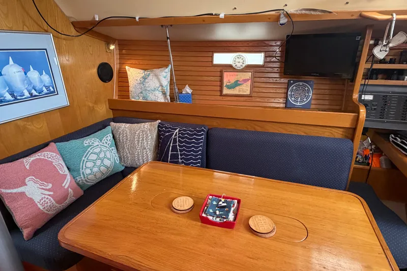 Slide: The Image of Cozy interior of 1988 Beneteau Oceanis 390 sailboat with nautical-themed decor. - 18