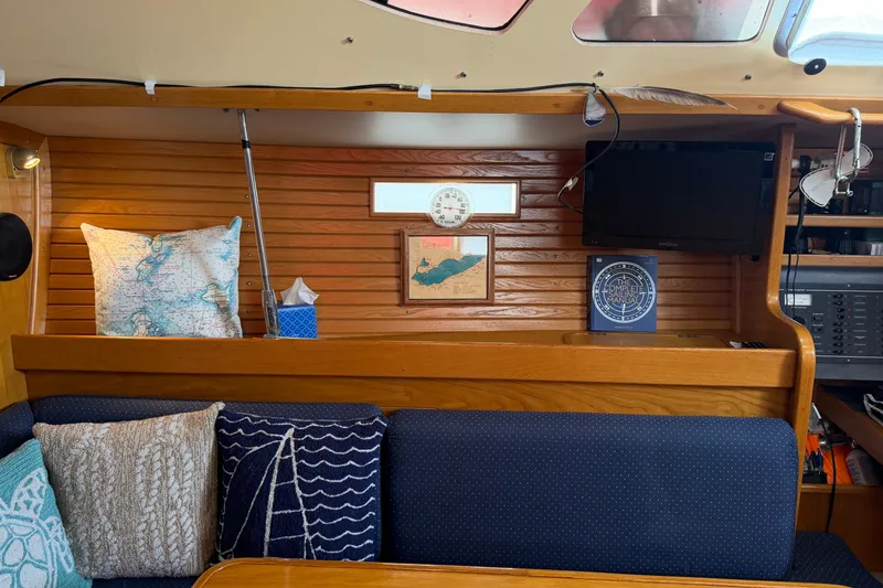 Slide: The Image of Interior of 1988 Beneteau Oceanis 390 sailboat with nautical decor and seating area. - 19