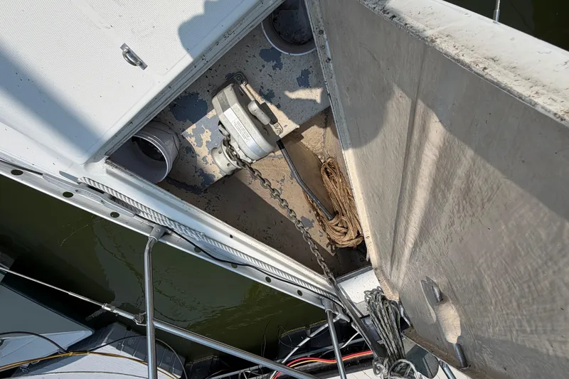 Slide: The Image of Anchor locker of a 1988 Beneteau Oceanis 390 sailboat, showing chain and rope storage. - 14