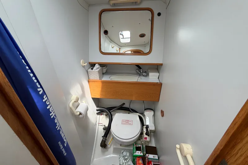 Slide: The Image of Compact bathroom in 1988 Beneteau Oceanis 390 sailboat with mirror and storage. - 37