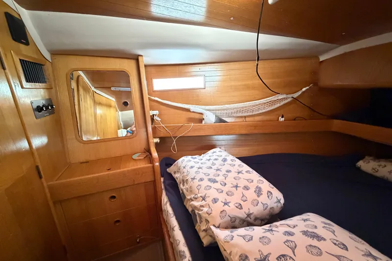 Slide: The Image of Cozy cabin interior of 1988 Beneteau Oceanis 390 sailboat with wooden finish and nautical decor. - 32