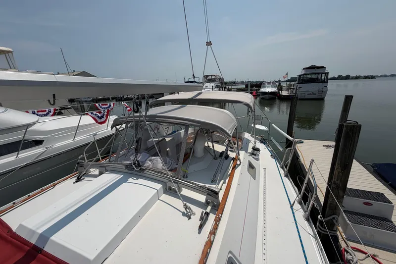 Slide: The Image of 1988 Beneteau Oceanis 390 sailboat docked at marina, sunny day, calm waters. - 13