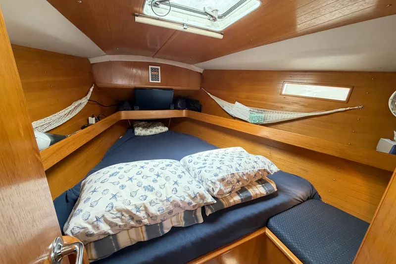 Slide: The Image of Cozy cabin interior of 1988 Beneteau Oceanis 390 sailboat with wooden finish and bedding. - 33