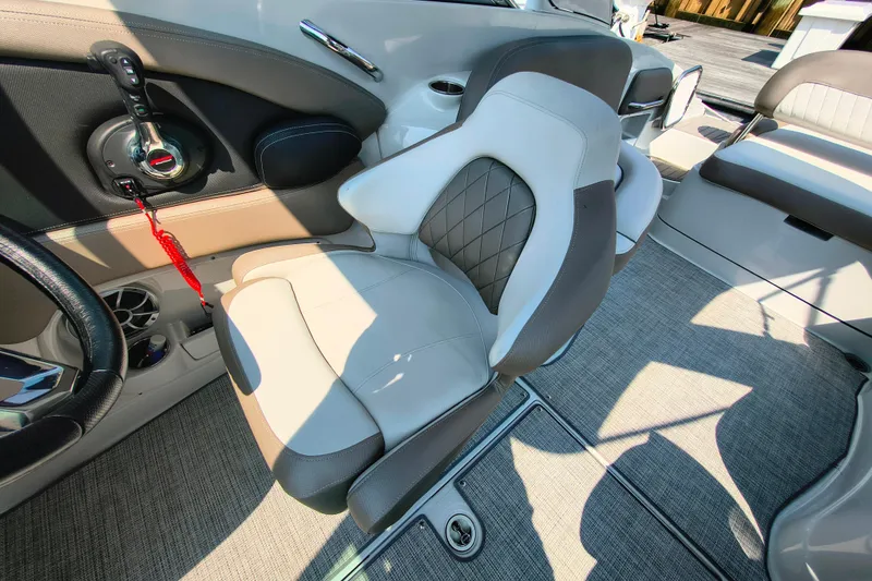 Slide: The Image of 2023 Crownline 290 SS boat interior with luxurious seating and modern controls. - 6