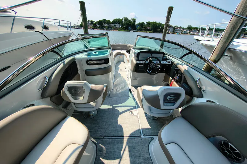 Slide: The Image of 2023 Crownline 290 SS boat interior with luxurious seating and modern dashboard. - 9