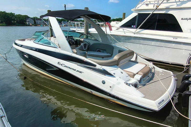 The Image of 2023 Crownline 290 SS boat docked, featuring sleek design and spacious seating. - 1