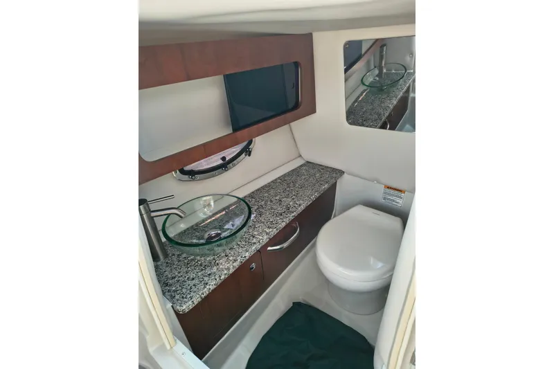 Slide: The Image of Luxurious 2023 Crownline 290 SS boat bathroom with granite countertop and modern fixtures. - 14