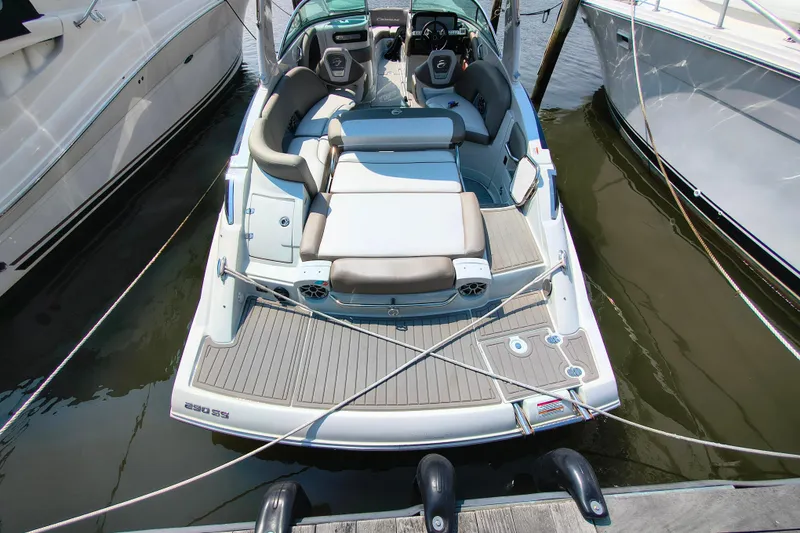 Slide: The Image of 2023 Crownline 290 SS boat docked, featuring spacious seating and modern design. - 7