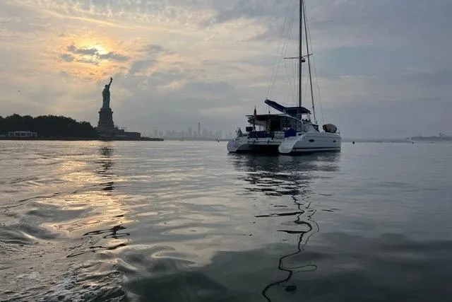The Image of Fountaine Pajot Lipari 41 catamaran sailing near Statue of Liberty at sunset, 2013 model. - 0