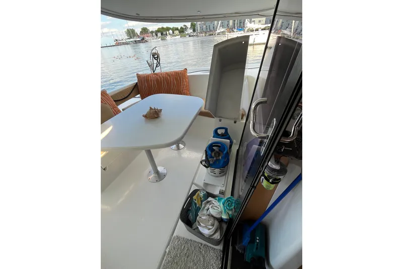 Slide: The Image of Interior view of 2013 Fountaine Pajot Lipari 41 catamaran with table and marina backdrop. - 5