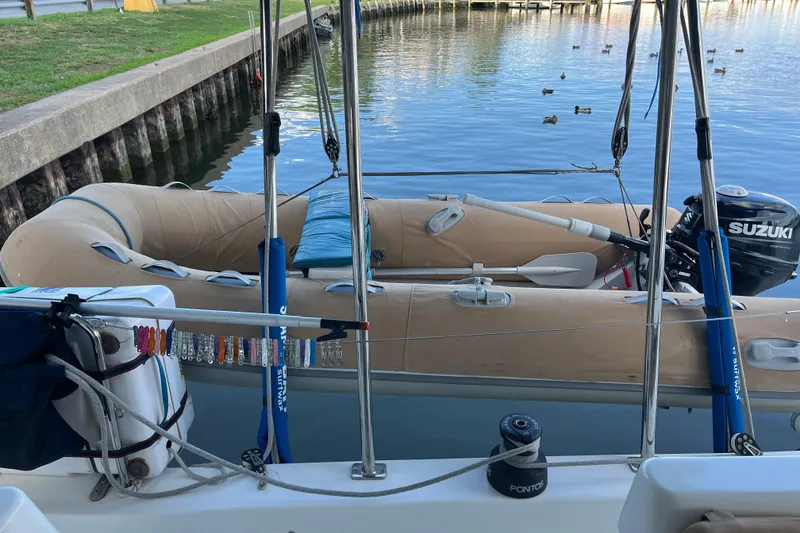 Slide: The Image of 2013 Fountaine Pajot Lipari 41 with inflatable dinghy and Suzuki outboard motor. - 17