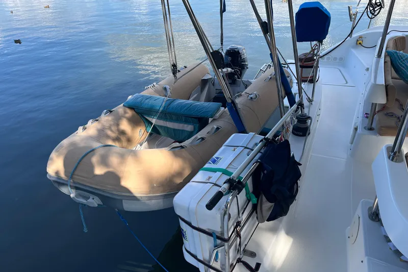 Slide: The Image of 2013 Fountaine Pajot Lipari 41 catamaran with dinghy on calm water. - 12