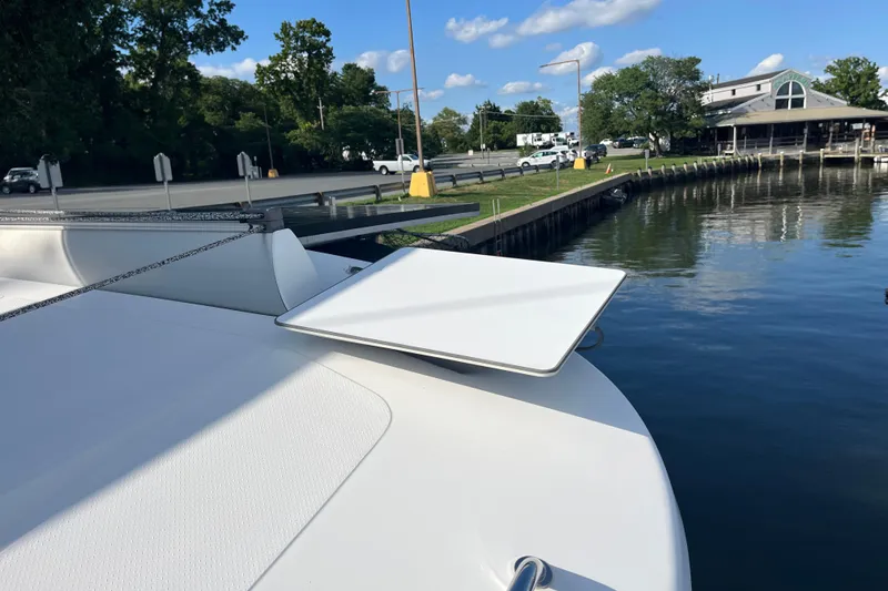 Slide: The Image of 2013 Fountaine Pajot Lipari 41 catamaran docked by a serene waterfront. - 10