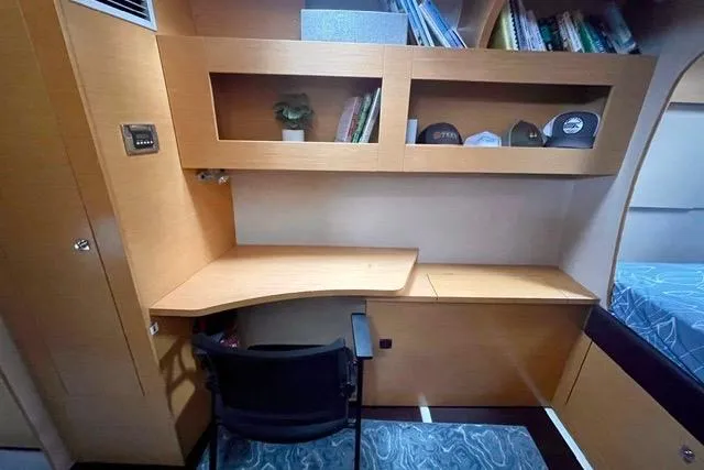 Slide: The Image of Interior of 2013 Fountaine Pajot Lipari 41 catamaran with wooden desk and shelving. - 23