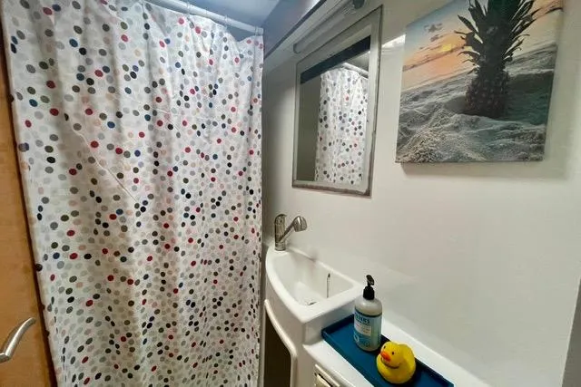 Slide: The Image of Bathroom interior of 2013 Fountaine Pajot Lipari 41 catamaran with polka dot shower curtain. - 27