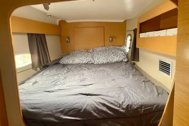 Slide: The Image of Cozy bedroom interior of 2013 Fountaine Pajot Lipari 41 catamaran with double bed and porthole. - 29