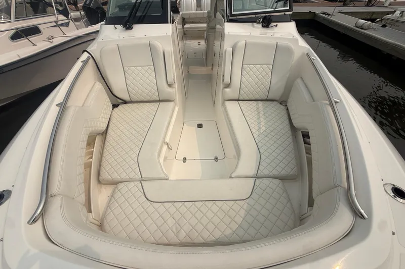 Slide: The Image of Luxurious seating on 2025 Pursuit DC 306 Dual Console boat, featuring elegant quilted upholstery. - 31