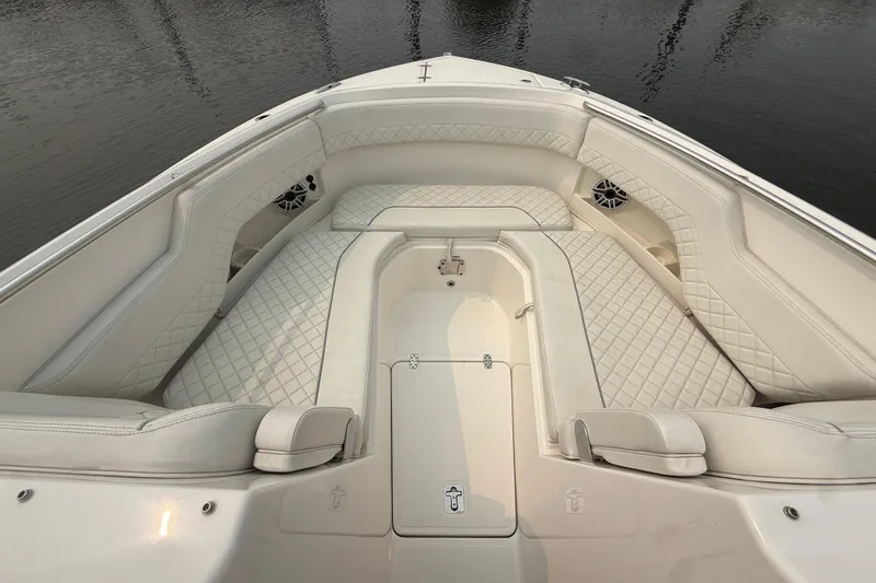 Slide: The Image of Luxurious seating area on 2025 Pursuit DC 306 Dual Console boat, featuring elegant white upholstery. - 29