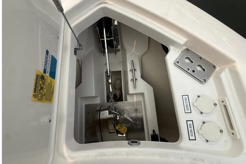 Slide: The Image of Anchor compartment of 2025 Pursuit DC 306 Dual Console boat with water access points. - 36