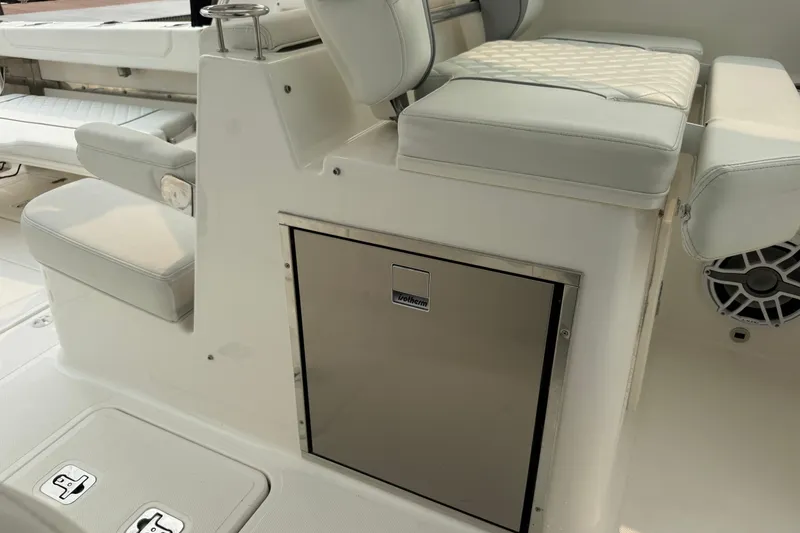 Slide: The Image of 2025 Pursuit DC 306 Dual Console interior with cushioned seating and built-in storage. - 14