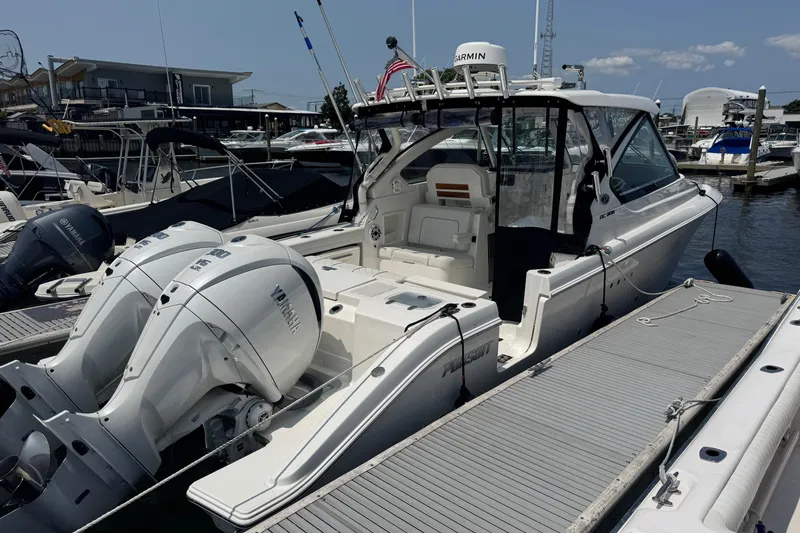 Slide: The Image of 2025 Pursuit DC 306 Dual Console boat docked with twin Yamaha engines. - 7