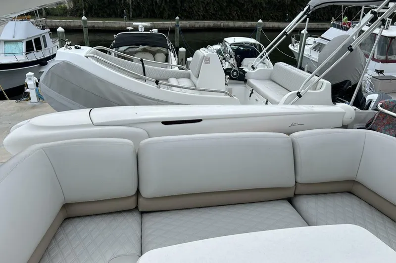 Slide: The Image of Luxurious seating on a 2008 Princess 67 Flybridge Motor Yacht, docked with other boats. - 16