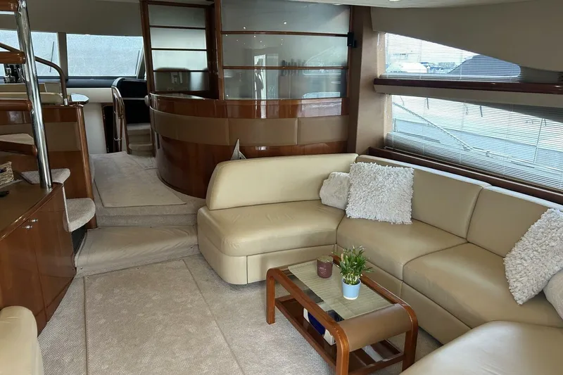 Slide: The Image of Luxurious interior of 2008 Princess 67 Flybridge Motor Yacht with beige seating and wooden accents. - 21