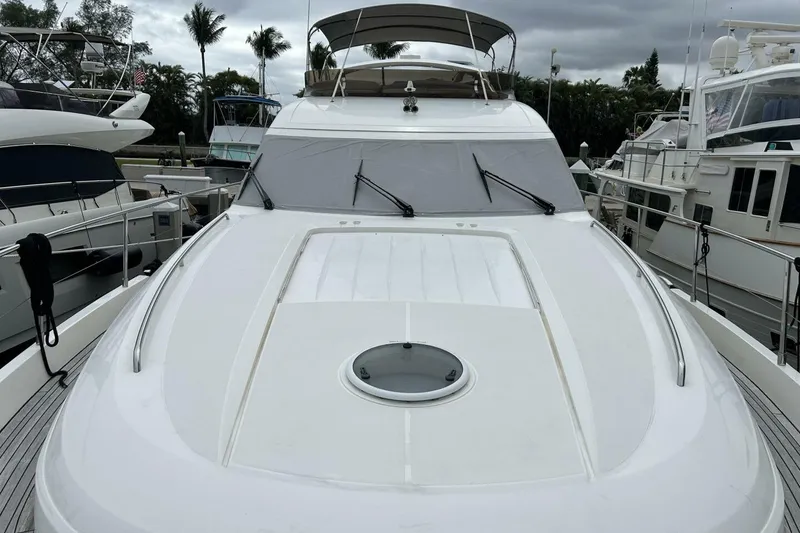Slide: The Image of 2008 Princess 67 Flybridge Motor Yacht docked, showcasing sleek design and spacious deck. - 13