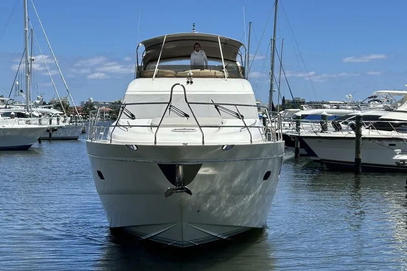 Slide: The Image of 2008 Princess 67 Flybridge Motor Yacht docked in a marina under clear blue skies. - 4