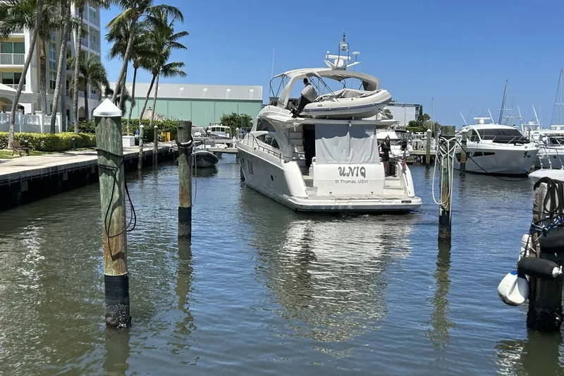 Slide: The Image of 2008 Princess 67 Flybridge Motor Yacht docked at marina, surrounded by palm trees and clear skies. - 6
