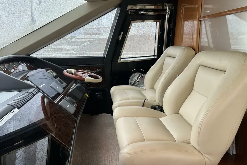 Slide: The Image of Interior of 2008 Princess 67 Flybridge Motor Yacht with beige leather seats and control panel. - 25