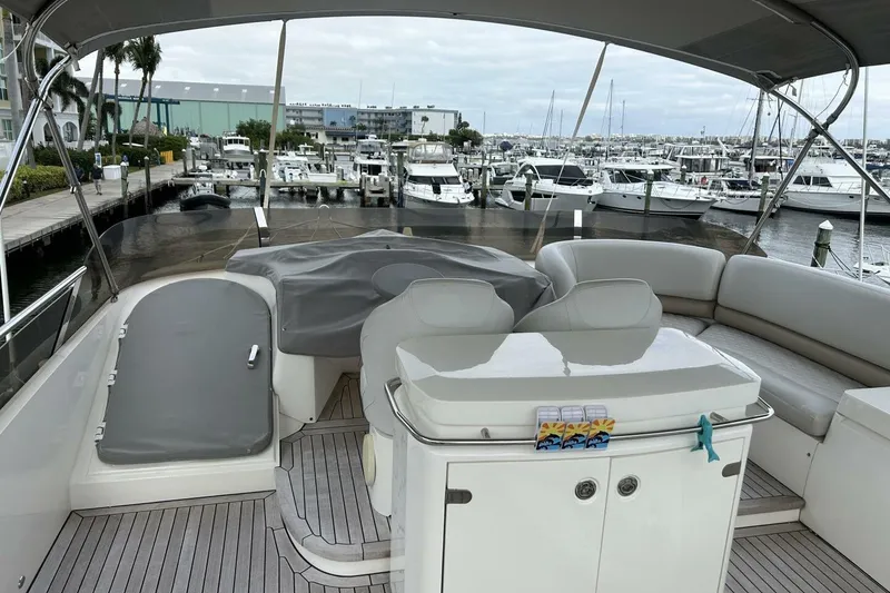 Slide: The Image of 2008 Princess 67 Flybridge Motor Yacht at marina, featuring spacious seating and covered helm. - 17