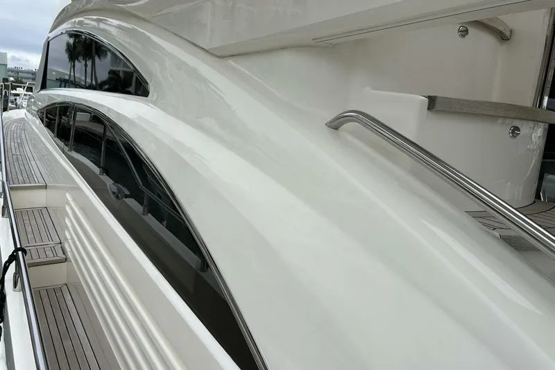 Slide: The Image of Side view of a 2008 Princess 67 Flybridge Motor Yacht with sleek design and polished railings. - 12