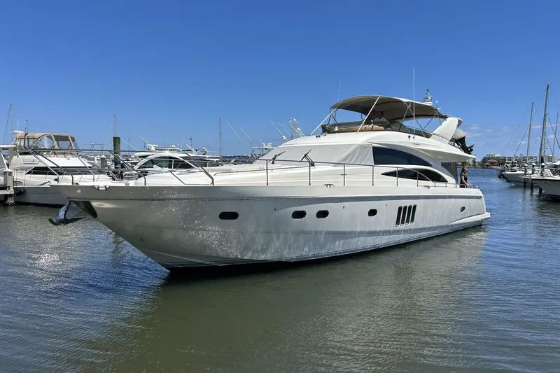 Slide: The Image of 2008 Princess 67 Flybridge Motor Yacht docked in a marina under clear blue skies. - 5