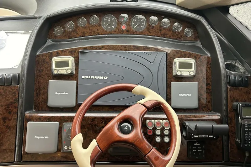 Slide: The Image of Cockpit of 2008 Princess 67 Flybridge Motor Yacht with navigation instruments and steering wheel. - 26